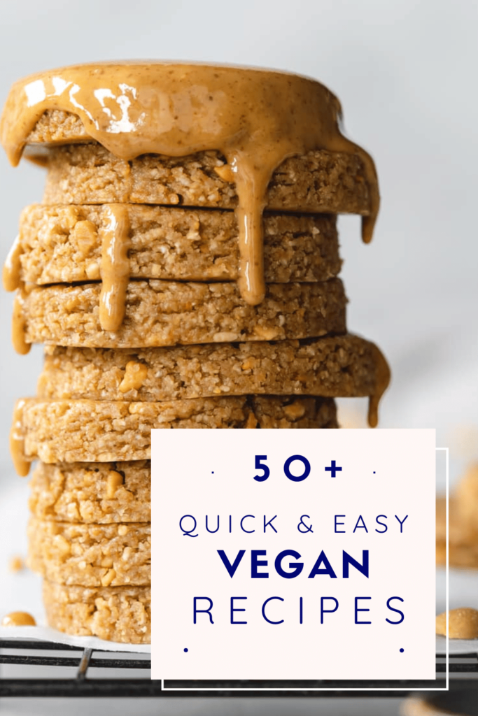 A tall, slightly uneven stack of flat, circular no-bake peanut butter cookies. Peanut butter is covering the top cookie and dribbling down the sides.